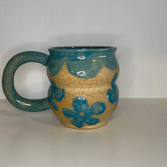 Ceramic mug with blue and beige design on a white background
