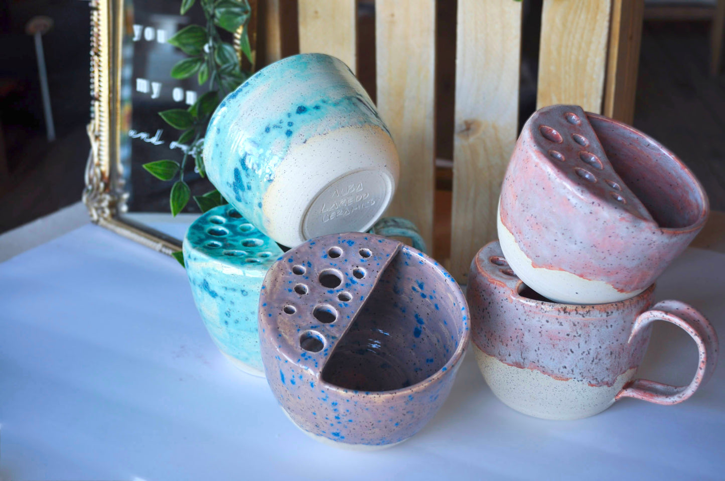 Set of ceramic pots with unique textures and colors on a light surface.