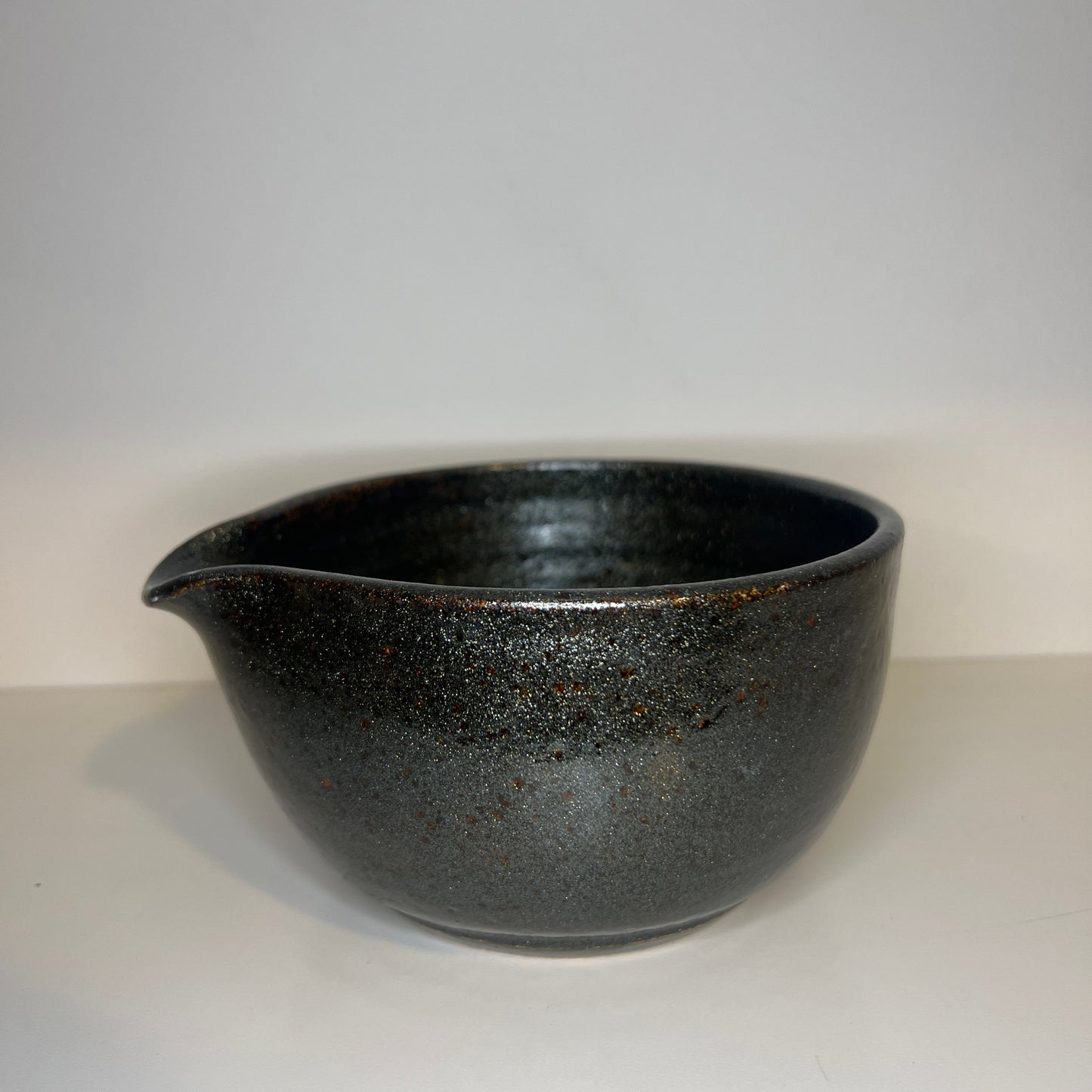 Black ceramic bowl on a white background