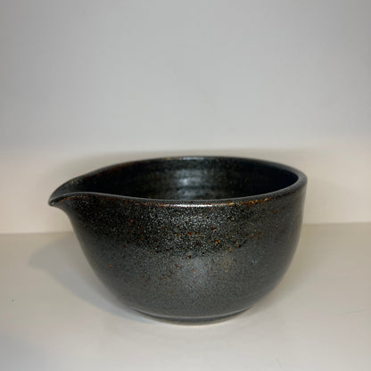 Black ceramic bowl on a white background