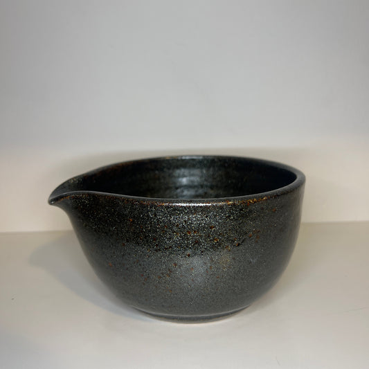 Black ceramic bowl on a white background