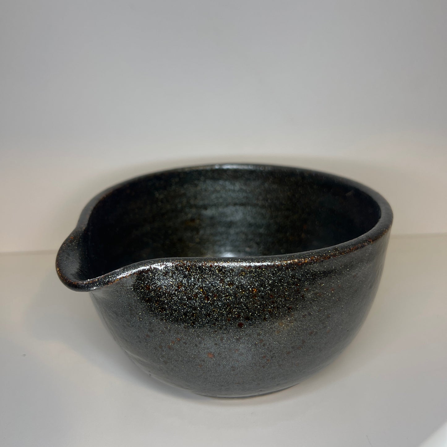 Black ceramic bowl on a white background