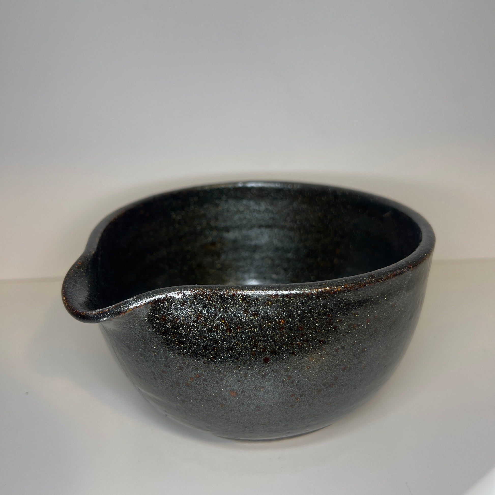 Black ceramic bowl on a white background