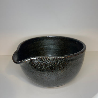 Black ceramic bowl on a white background