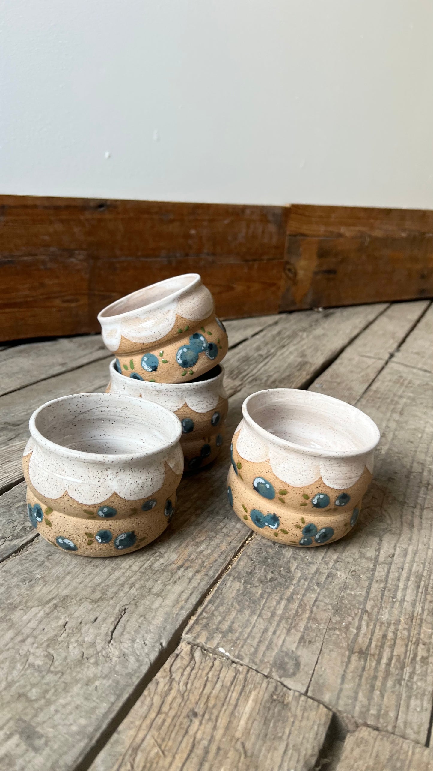 Set of ceramic pots with decorative patterns on a wooden surface