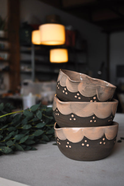 Stack of ceramic bowls with decorative patterns on a blurred background