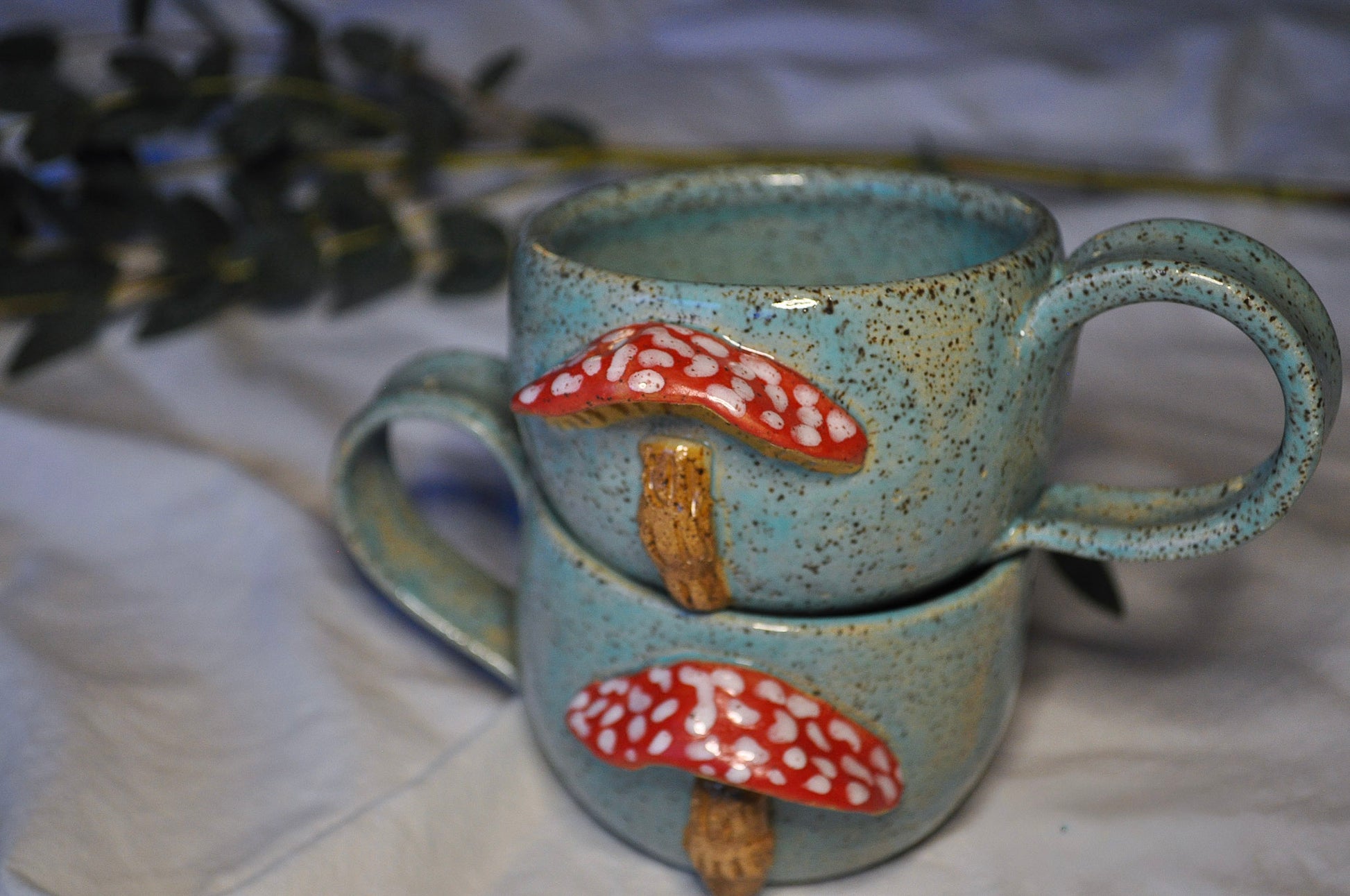 Ceramic mug with mushroom design on a white surface