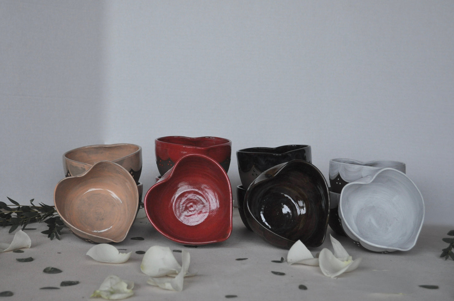 Set of ceramic bowls in various colors on a neutral background