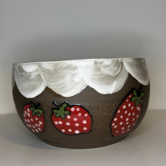 Dark brown ceramic bowl with strawberry designs and added with a red inside and The red rim features a hand-glazed swooping design that adds movement and visual interest. The bowl is against a white background
