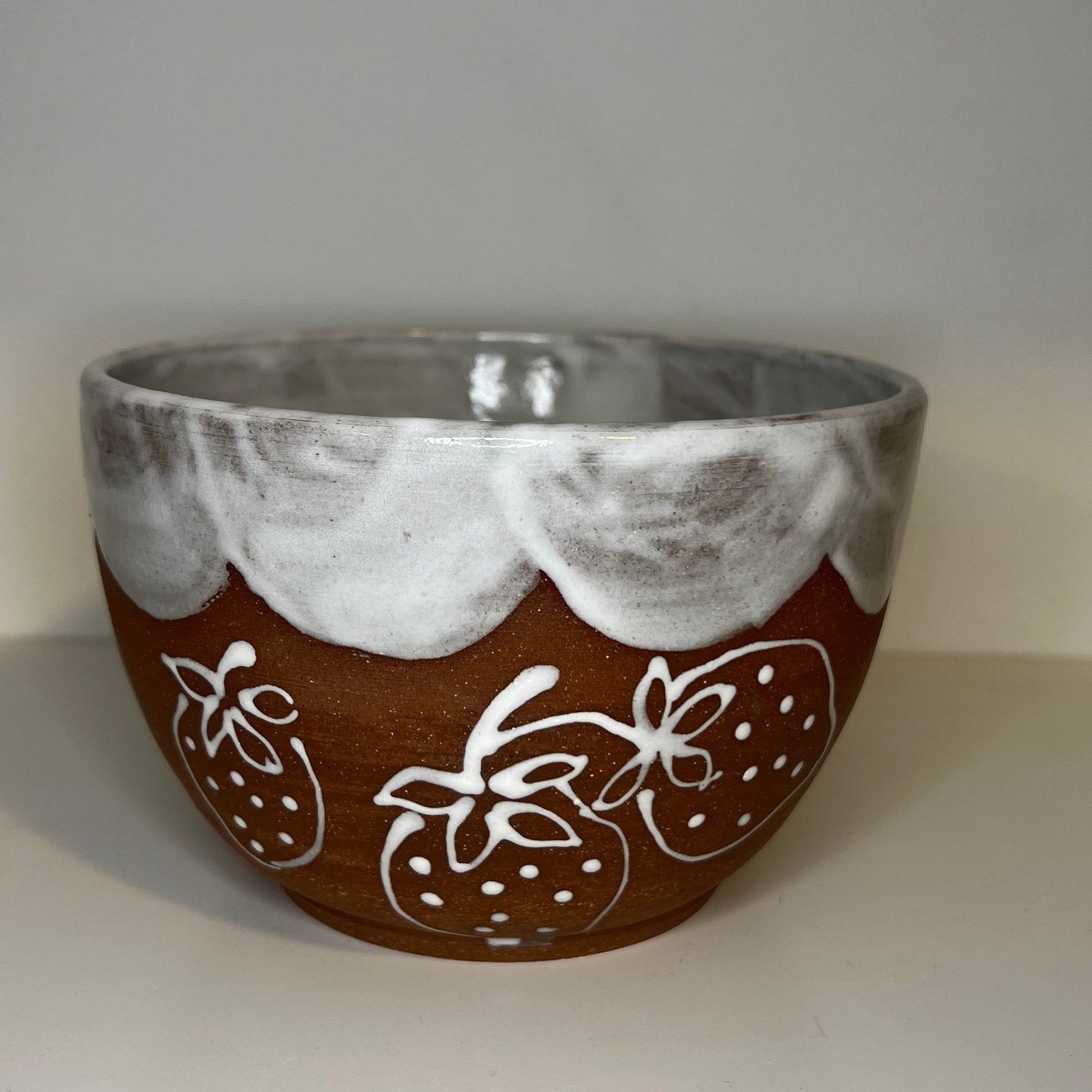 Ceramic bowl with decorative patterns on a white surface